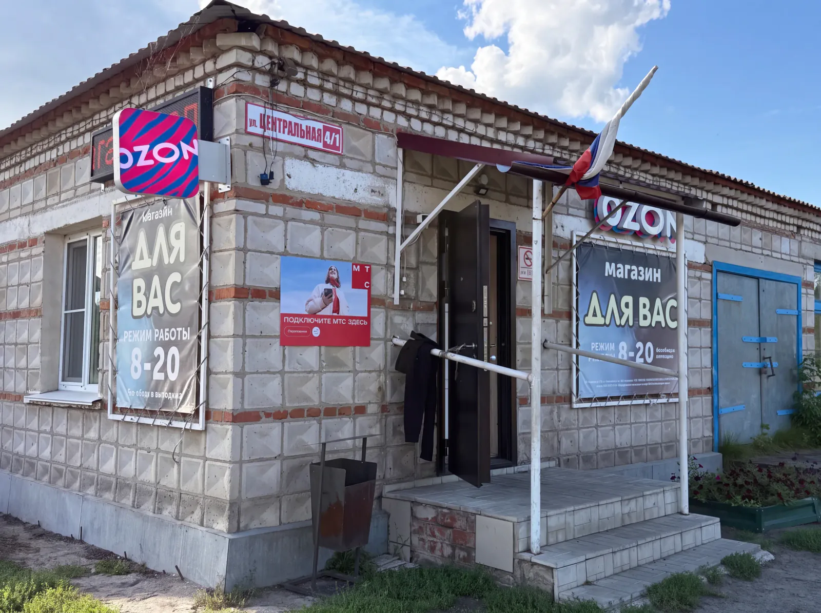 Магазин «Для Вас» и пункт выдачи Ozon, ул. Центральная, 4/1: белое кирпичное здание с вывесками OZON, крыльцо, летом